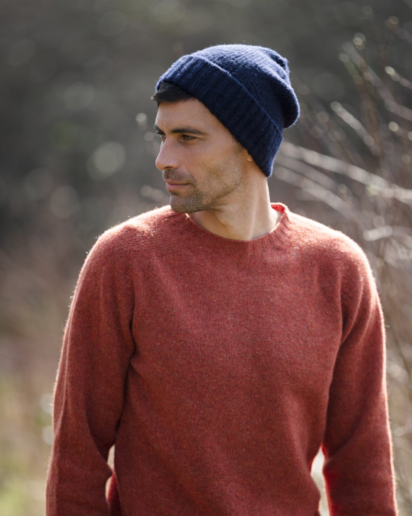 Man wearing a navy brushed Shetland wool beanie lambswool hat by Bosie Knitwear