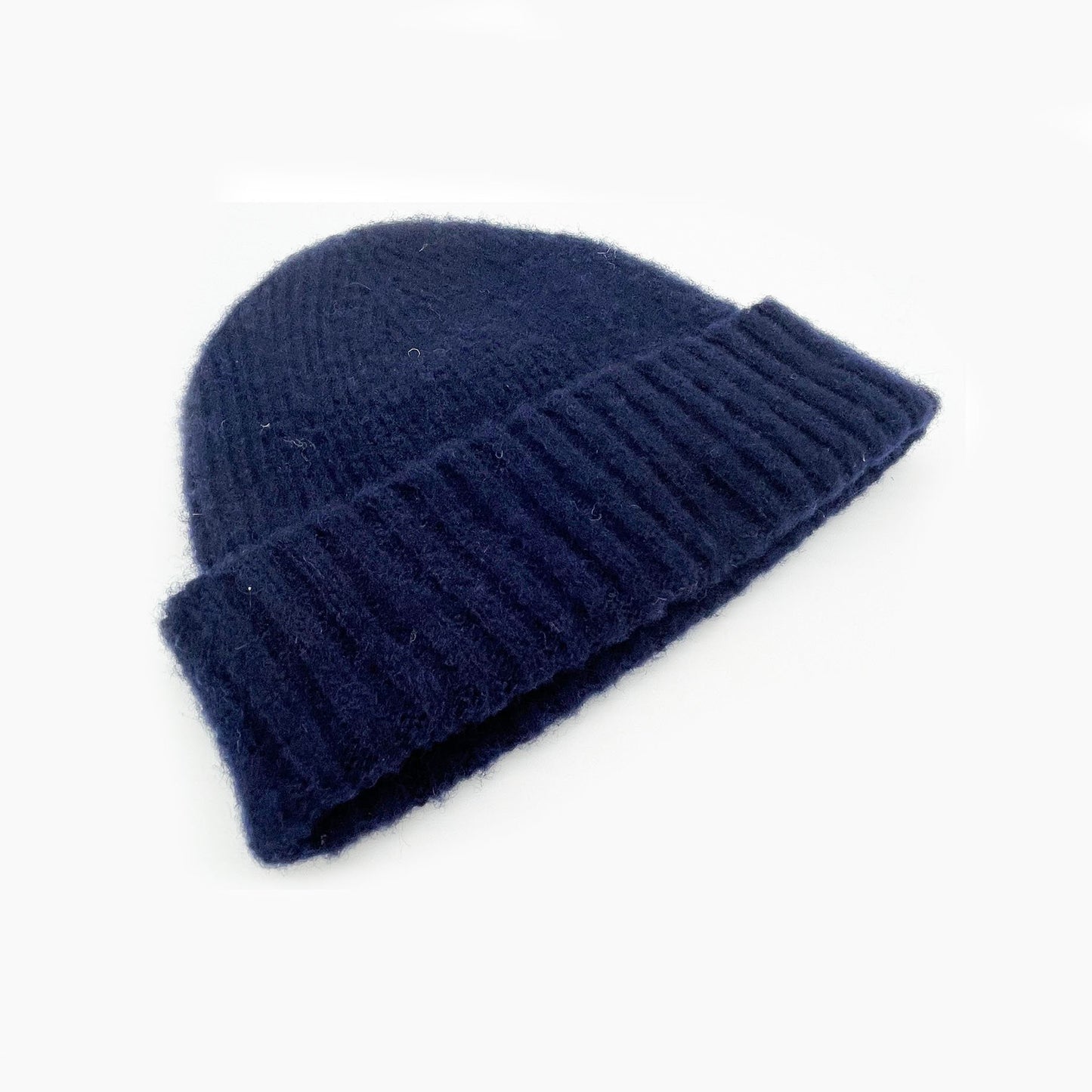 Flatbed Photograph of a navy brushed Shetland wool beanie lambswool hat by Bosie Knitwear