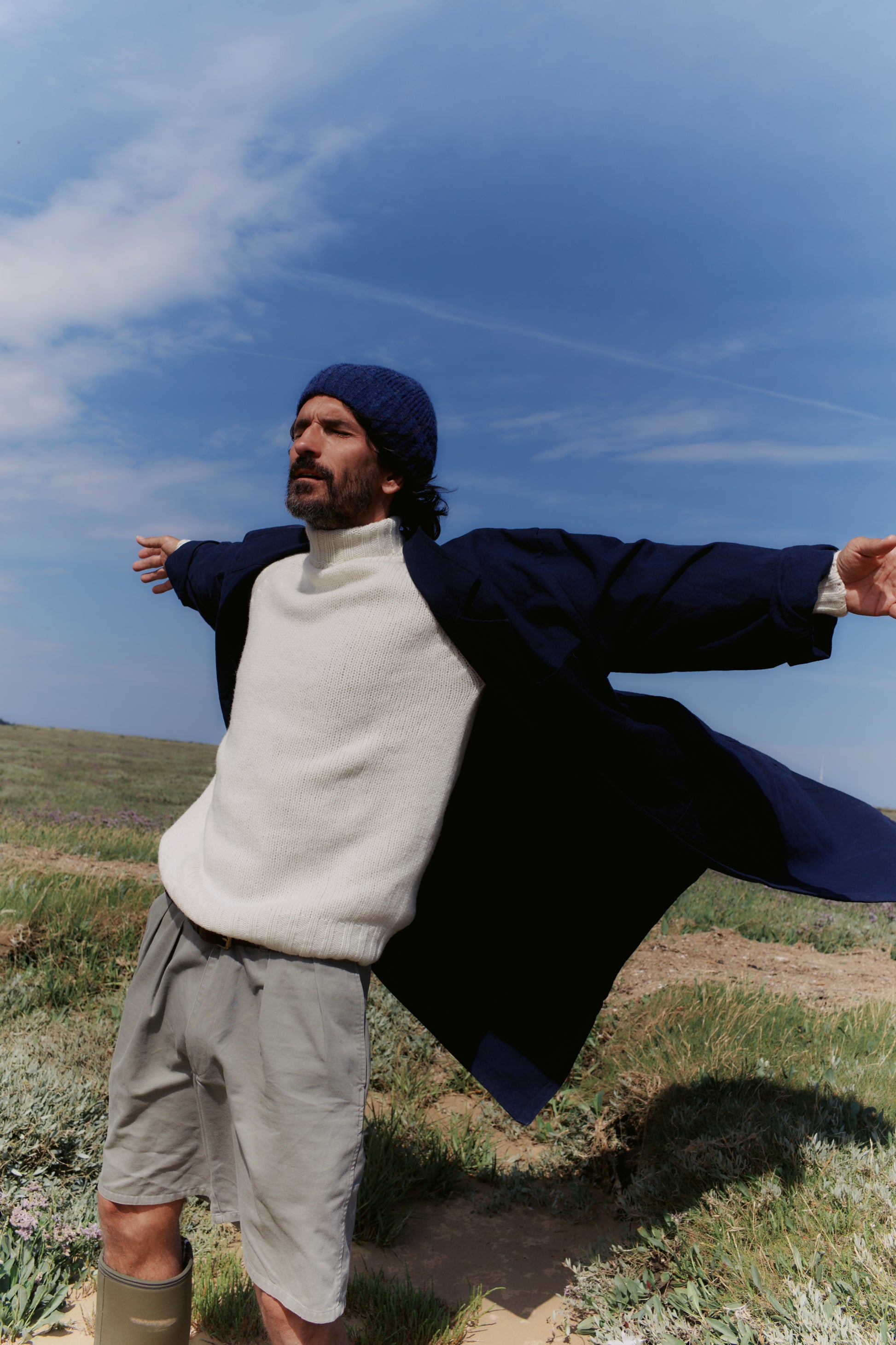 Man wearing a Blue Mogganer Submariner Polo Neck Shetland Chunky Sweater in Winter White by Bosie Knitwear