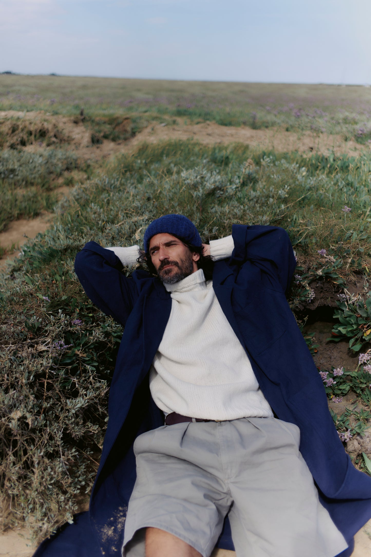 Man wearing a Blue Mogganer Submariner Polo Neck Shetland Chunky Sweater in Winter White by Bosie Knitwear